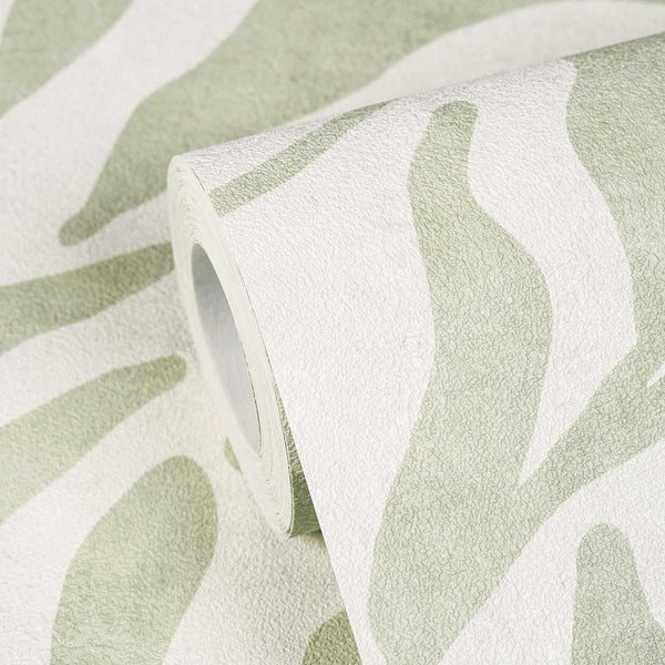 AS Creation Cosiness 793142 close up of a wallpaper roll showing an abstract wavy pattern in Green, partially unrolled on the matching surface.