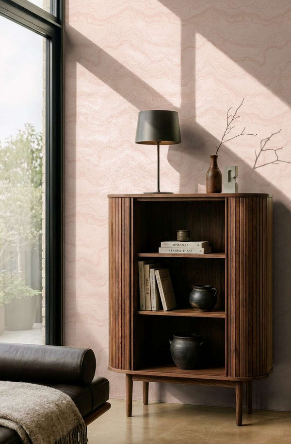 AS Creation Cosiness 793165 living room with Metallic, Pink wavy pattern wallpaper, shown with a wooden cabinet and a table lamp.