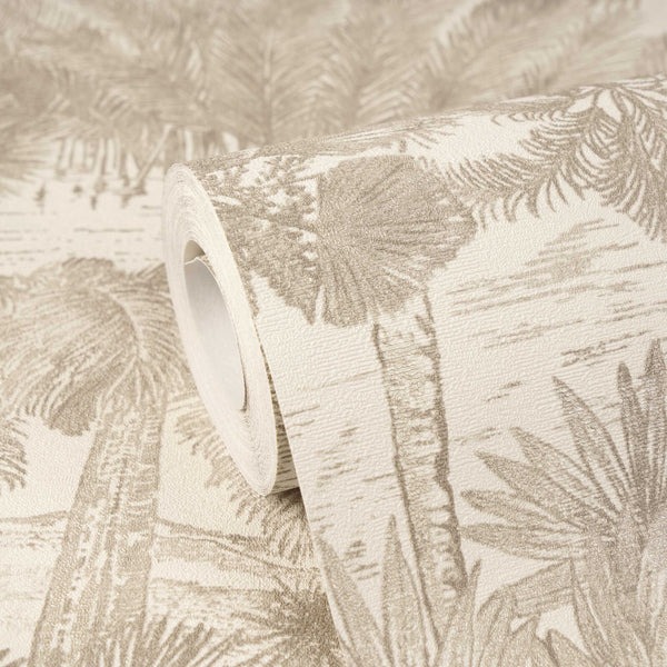 AS Creation Cosiness 793172 wallpaper roll with a tropical palm tree and leaf pattern in Beige, Brown, Metallic, resting on a matching unrolled sheet.