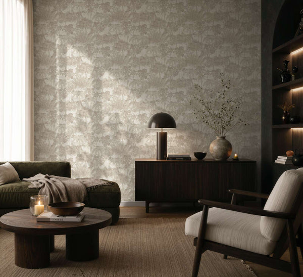 AS Creation Cosiness 793172 living room with Beige and Brown wallpaper featuring a tonal botanical foliage pattern with Metallic accents, shown with a sofa and sideboard.