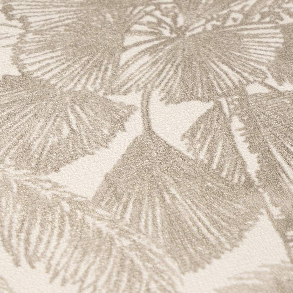 AS Creation Cosiness 793172 close up of wallpaper showing a textured botanical leaf pattern in Beige, Brown, and Metallic tones.