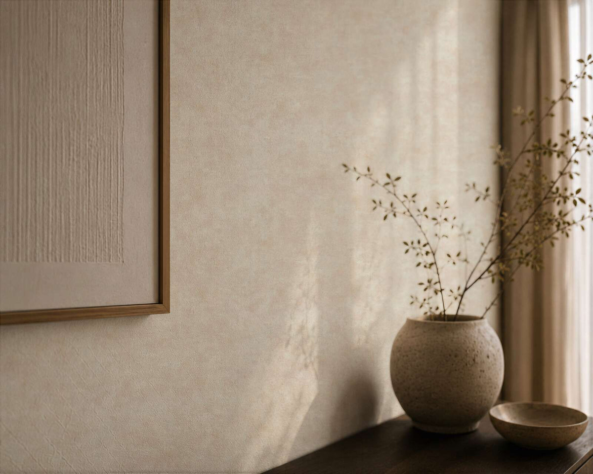 AS Creation Cosiness 793183 close up of Cream, Metallic wallpaper with a soft tonal effect, shown behind a ceramic vase with branches and a shallow bowl on a table.