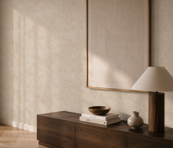 AS Creation Cosiness 793183 living room with cream and metallic wallpaper behind a wooden console and a table lamp.