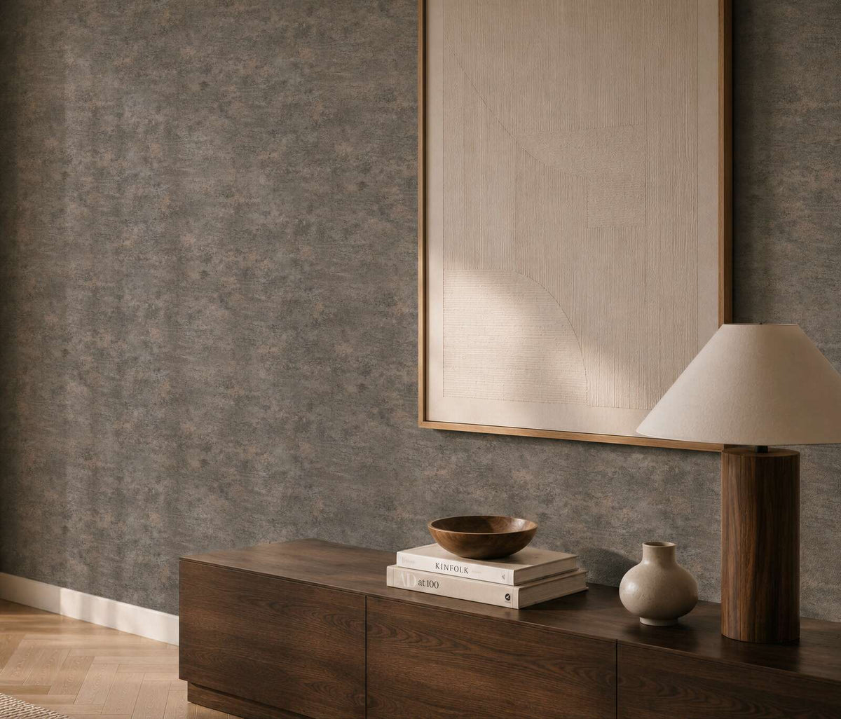 AS Creation Cosiness 793186 living room with black, grey, and metallic wallpaper featuring a subtle mottled look, shown behind a wooden sideboard and a table lamp.