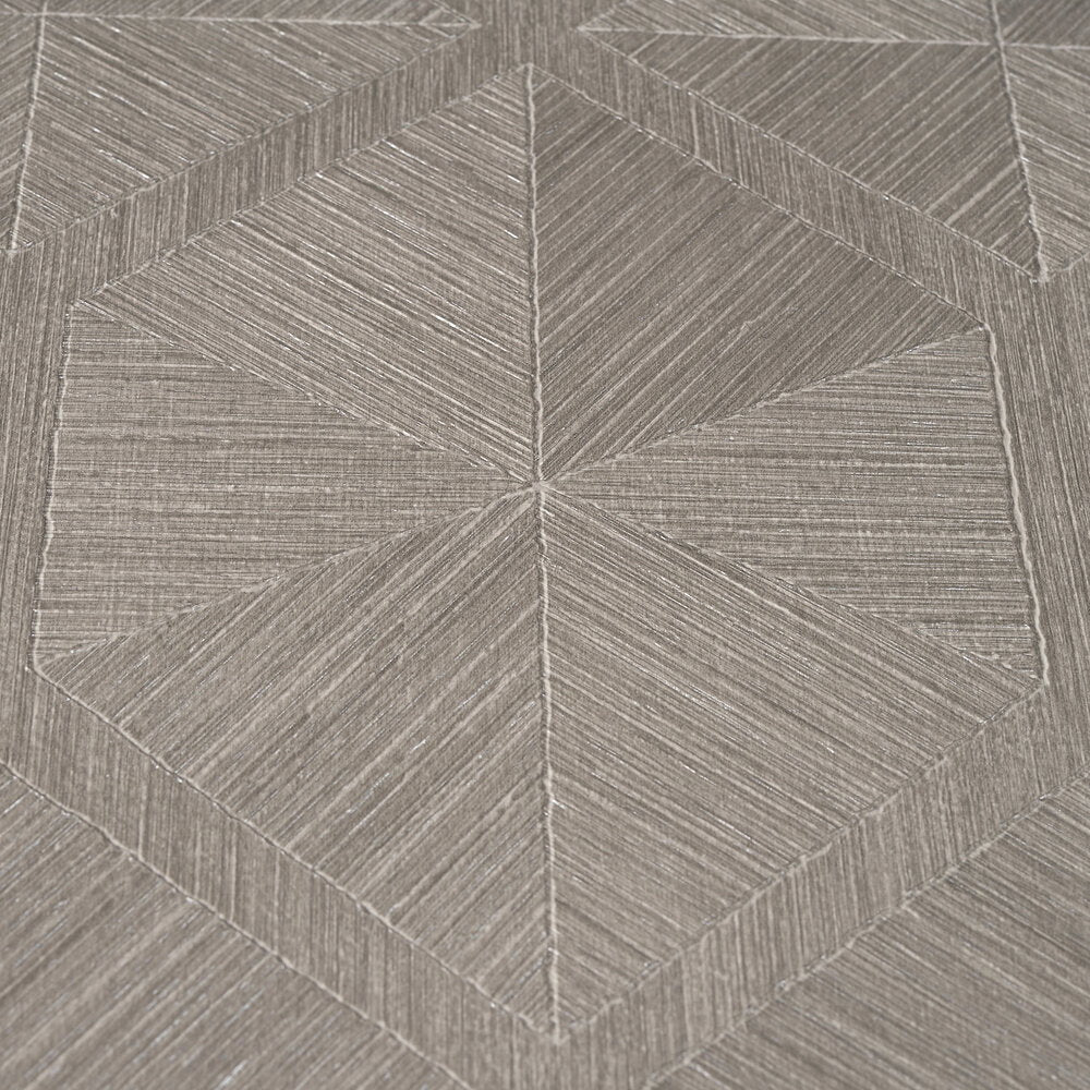 AS Creation Cosiness 793194 close up of grey, metallic wallpaper with angled linear stripes forming geometric diamonds and chevrons.