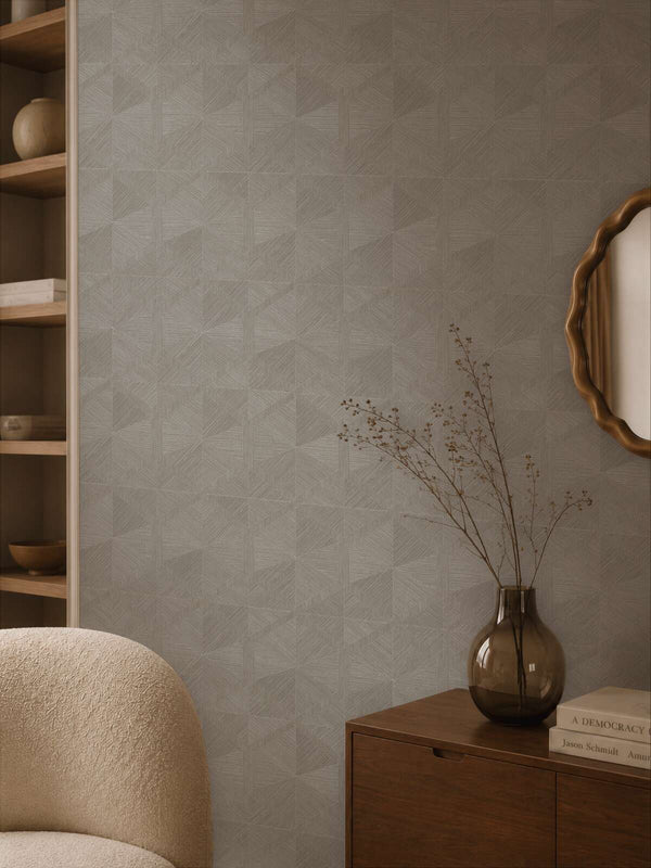 AS Creation Cosiness 793194 living room featuring Grey, Metallic geometric wallpaper with an armchair and a wooden sideboard.