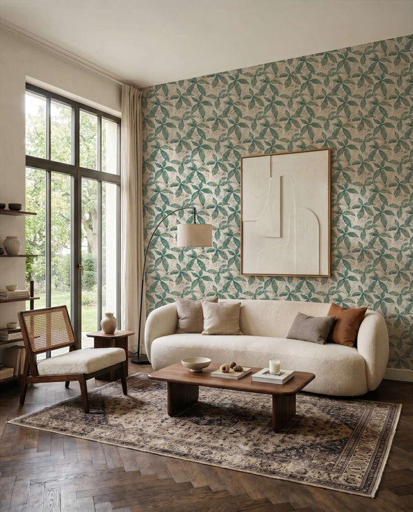 AS Creation Cosiness 793201 living room with Beige, Cream, and Green geometric leaf wallpaper behind a sofa and coffee table.
