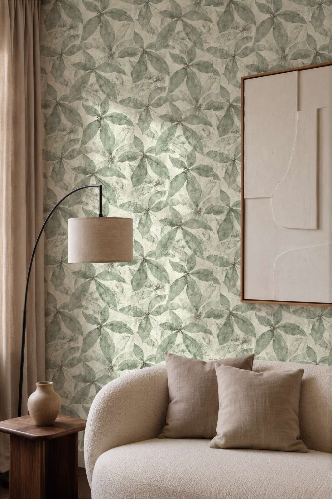 AS Creation Cosiness 793202 living room with Cream, Green leaf pattern wallpaper, a curved sofa and a floor lamp.