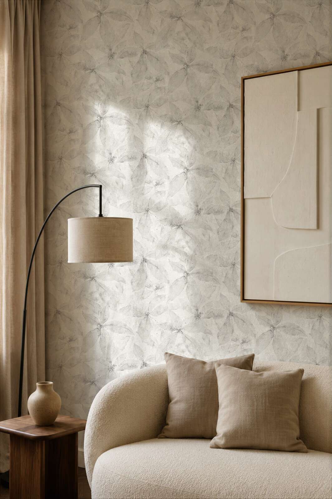AS Creation Cosiness 793203 living room with grey wallpaper featuring an overlapping petal motif, with a curved floor lamp and a sofa.
