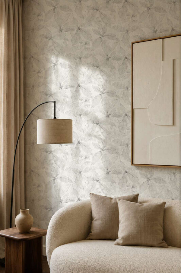 AS Creation Cosiness 793203 living room with grey wallpaper featuring an overlapping petal motif, with a curved floor lamp and a sofa.