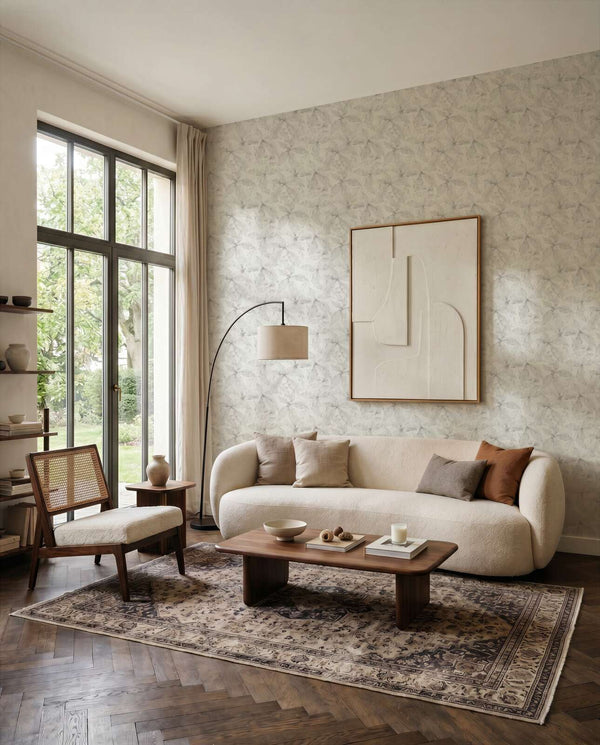 AS Creation Cosiness 793203 grey wallpaper with a subtle geometric pattern in a living room, shown with a sofa and coffee table.