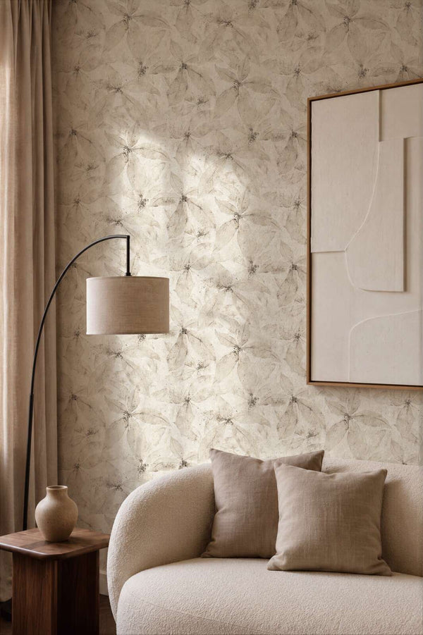 AS Creation Cosiness 793204 living room with Beige, Cream wallpaper featuring a layered petal pattern, shown behind a curved sofa and a floor lamp.
