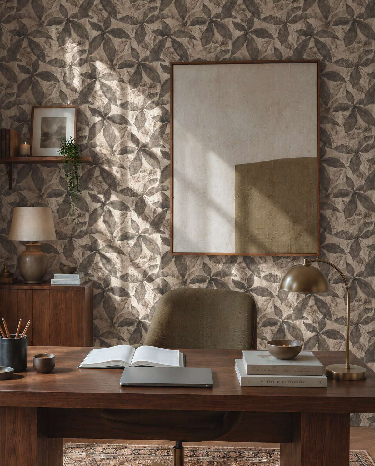 AS Creation Cosiness 793205 a home office with Beige, Brown wallpaper featuring a large petal motif behind a wooden desk and a desk lamp.
