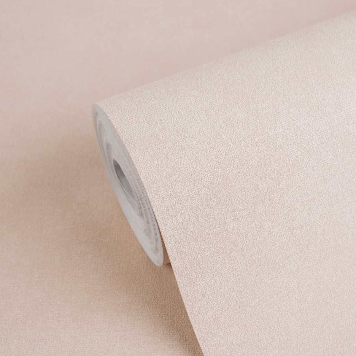 AS Creation French Affair 393417 wallpaper roll in Pink with a fine speckled texture, shown partly unrolled.