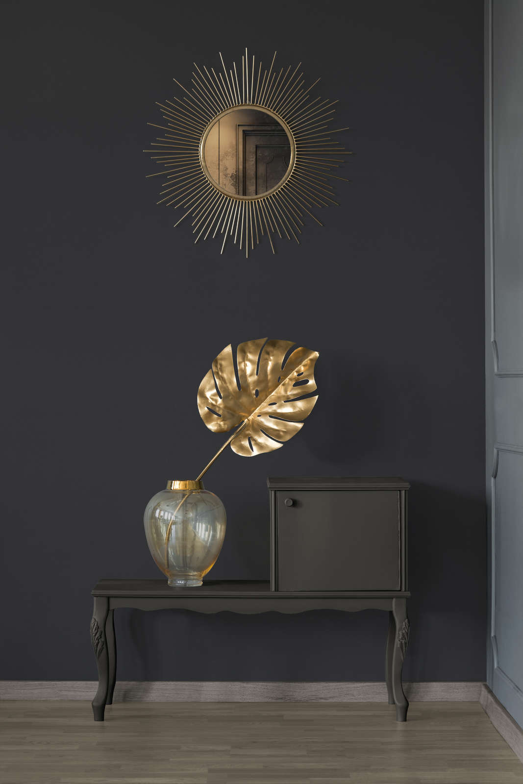 AS Creation French Affair 395726 entryway with Black wallpaper behind a console table and a round sunburst mirror.