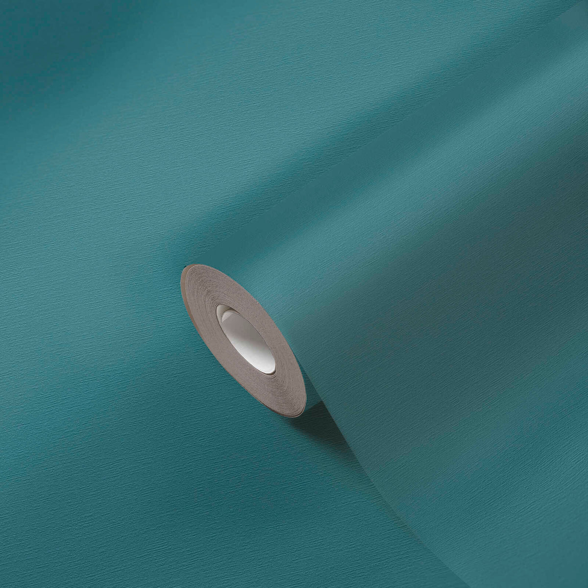 AS Creation French Affair 395764 blue, Green solid color wallpaper roll partially unrolled on a matching surface.