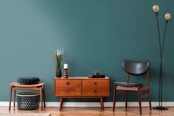 AS Creation French Affair 395764 living room with Blue, Green wallpaper behind a wooden sideboard and a black chair.