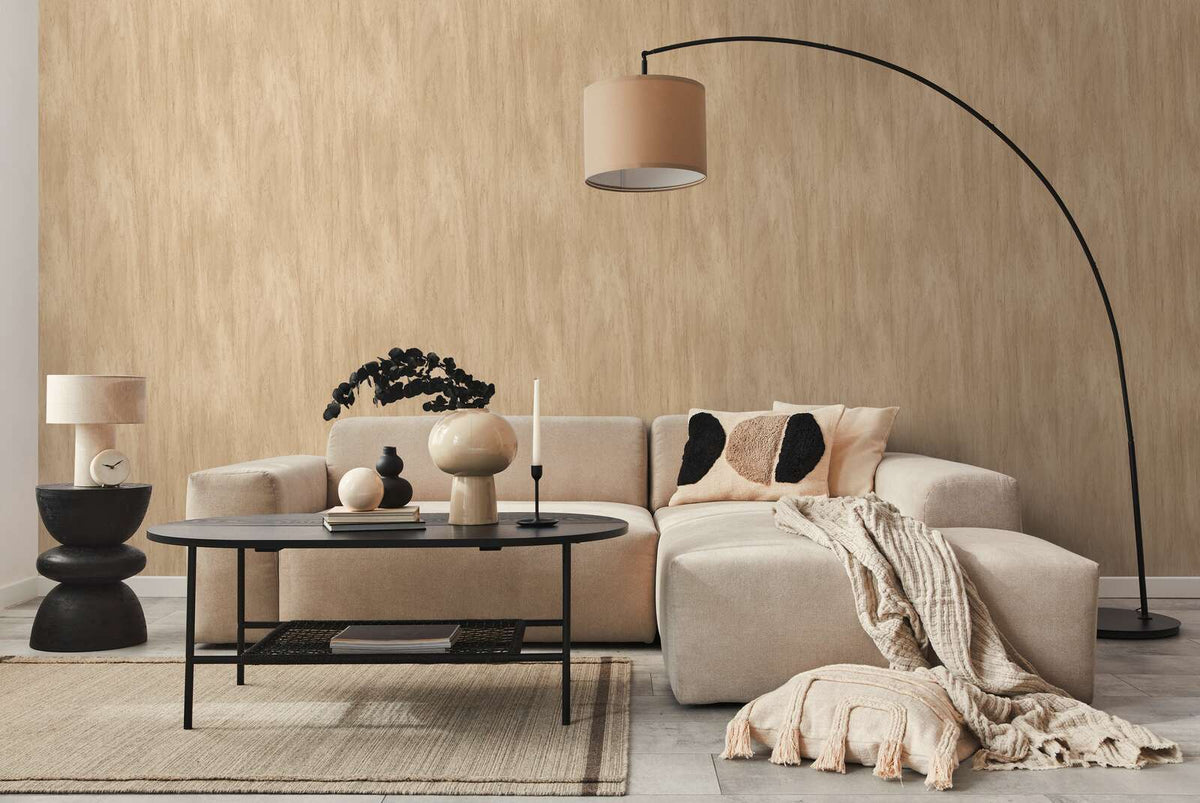 AS Creation French Affair 398012 living room with Beige wallpaper behind a sectional sofa and an arc floor lamp.