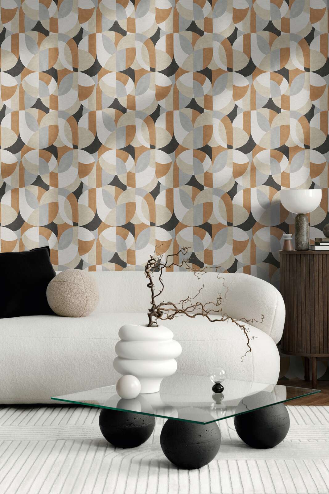 AS Creation French Affair 399321 living room with geometric wallpaper behind a curved sofa and a glass coffee table.