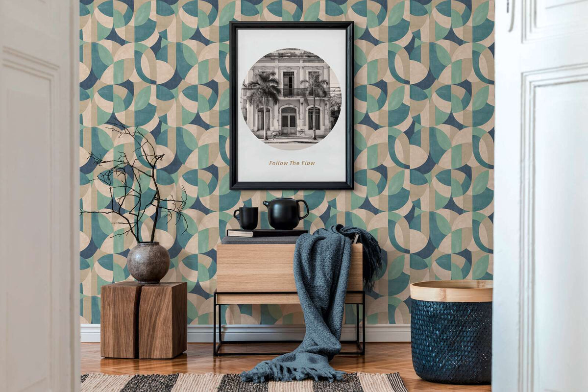 AS Creation French Affair 399322 a living room with geometric Beige, Blue, Cream, Green, and Turquoise wallpaper behind a framed wall art and a wood console.