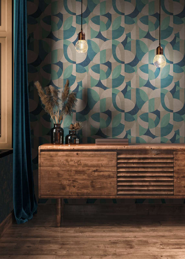 AS Creation French Affair 399322 living room scene with geometric Beige, Blue, Cream, Green, Turquoise wallpaper behind a wooden sideboard and two pendant lights.