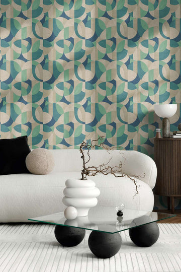 AS Creation French Affair 399322 living room with geometric wallpaper behind a curved sofa and a glass coffee table.