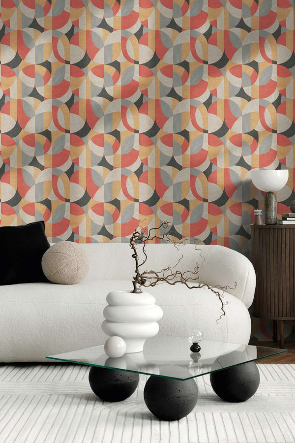 AS Creation French Affair 399323 living room with geometric wallpaper in Beige, Black, Grey, and Red behind a white sofa and a glass coffee table.