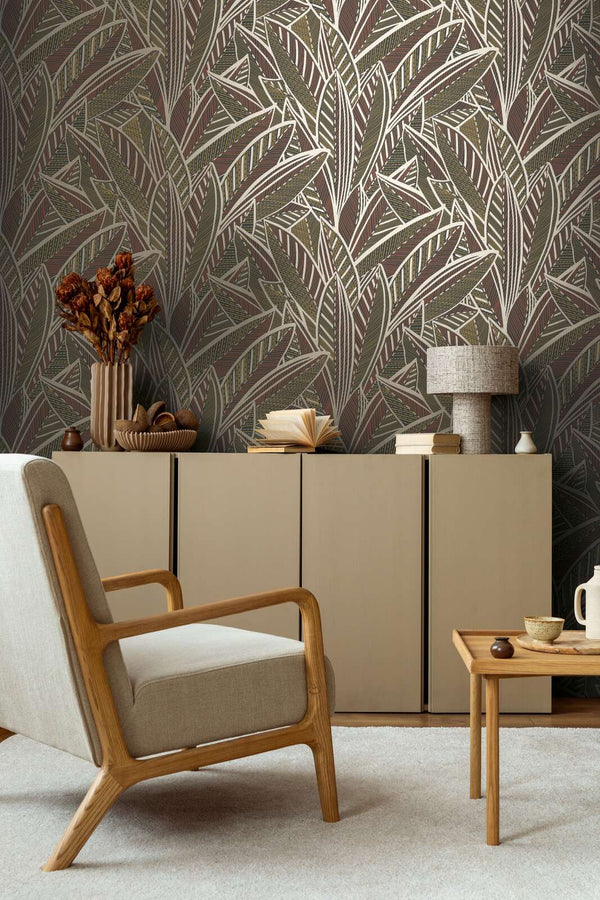 AS Creation French Affair 399331 living room with leaf pattern wallpaper behind a beige sideboard and a wooden armchair.