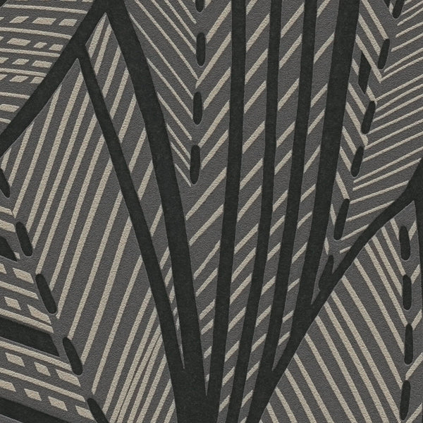 AS Creation French Affair 399334 close up of wallpaper showing a bold leaf motif with diagonal stripes and dotted accents in Black and Gold Metallic.