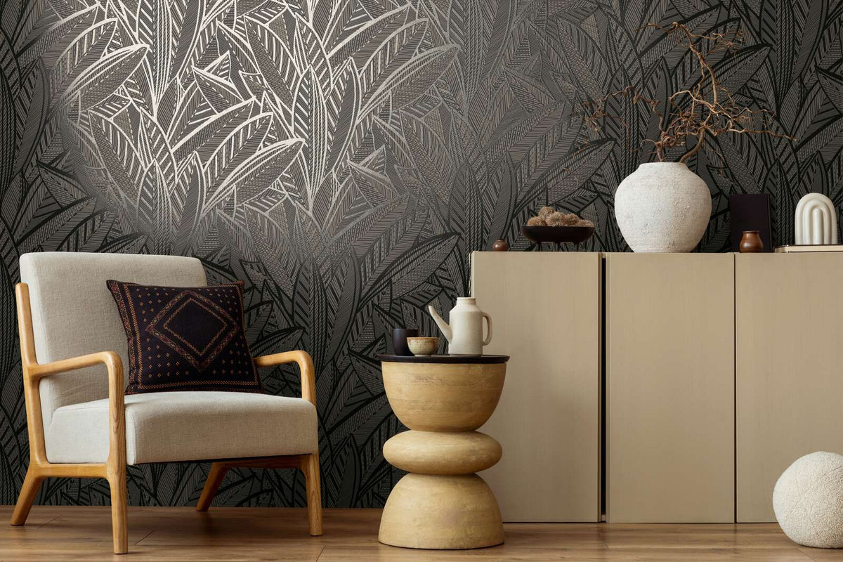 AS Creation French Affair 399334 large overlapping leaf motif with fine linear detailing in a Black, Gold, Metallic colorway wallpaper on a living room feature wall.