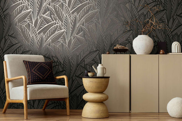 AS Creation French Affair 399334 large overlapping leaf motif with fine linear detailing in a Black, Gold, Metallic colorway wallpaper on a living room feature wall.