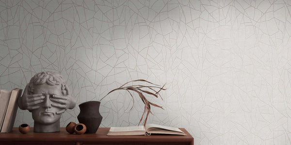AS Creation French Affair 399341 grey and White wallpaper with an abstract irregular line pattern behind a wooden console holding a sculpture, a vase with dried leaves, and an open book.