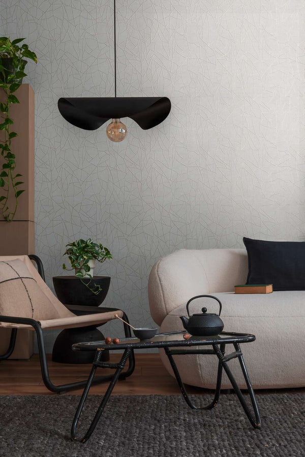 AS Creation French Affair 399341 living room with Grey, White wallpaper featuring an abstract interlacing line pattern, shown with a sofa and a pendant light.