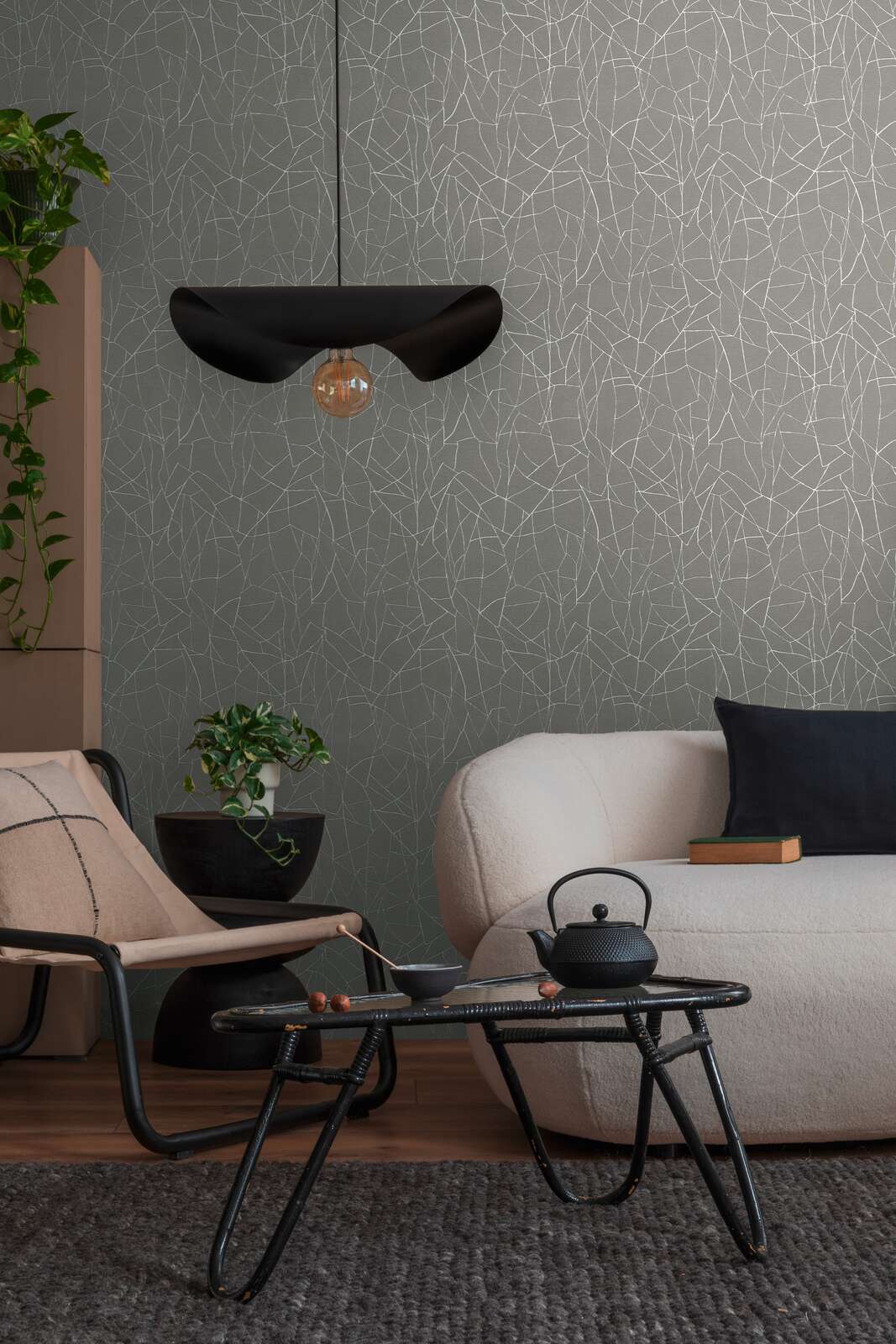 AS Creation French Affair 399343 living room with Grey and White wallpaper featuring an abstract line pattern, shown with a sofa and a coffee table.