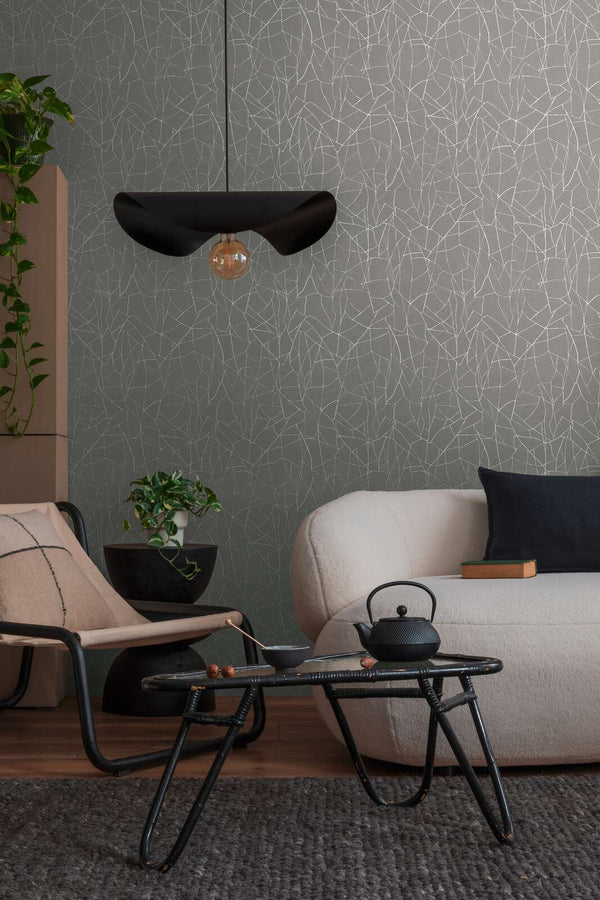 AS Creation French Affair 399343 living room with Grey and White wallpaper featuring an abstract line pattern, shown with a sofa and a coffee table.