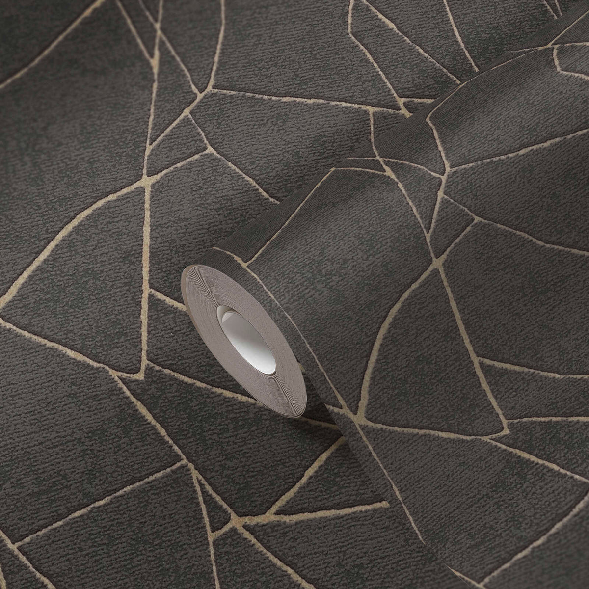 AS Creation French Affair 399344 wallpaper roll resting on an unrolled sheet showing an abstract angular line pattern in Black with Gold Metallic accents.