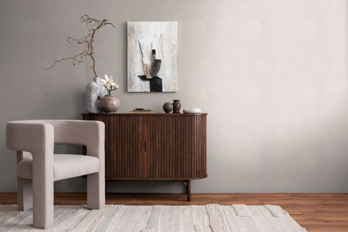 AS Creation French Affair 399351 living room with Grey and White wallpaper featuring a subtle abstract pattern behind a wooden sideboard and an upholstered chair.