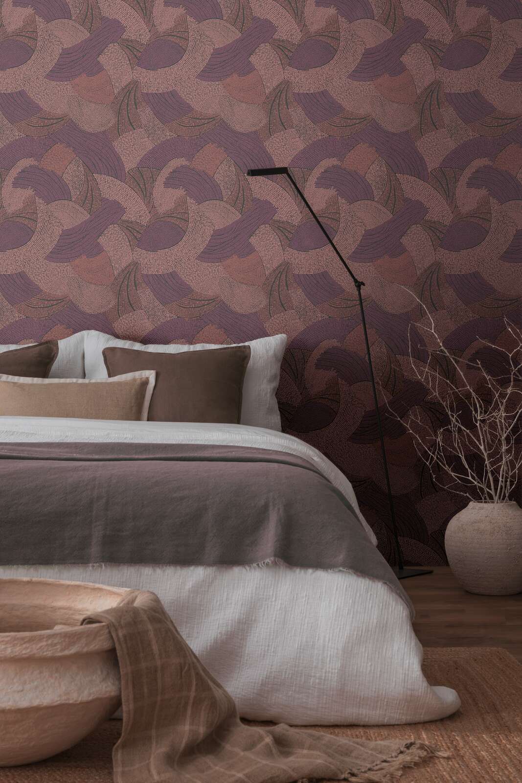 AS Creation French Affair 399352 red abstract pattern wallpaper in a bedroom with a bed and floor lamp.