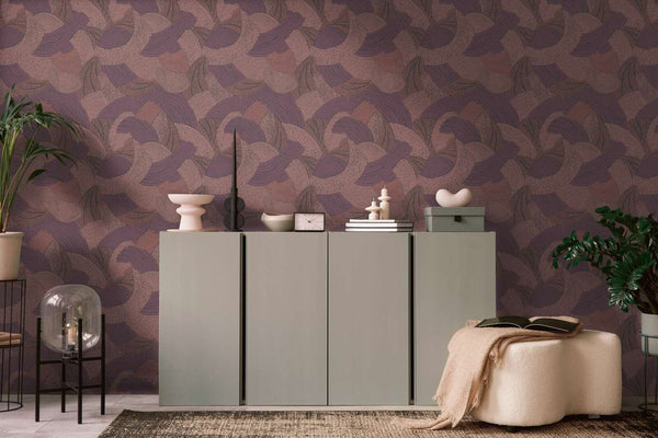 AS Creation French Affair 399352 living room with Red abstract patterned wallpaper behind a low sideboard and a cushioned ottoman.