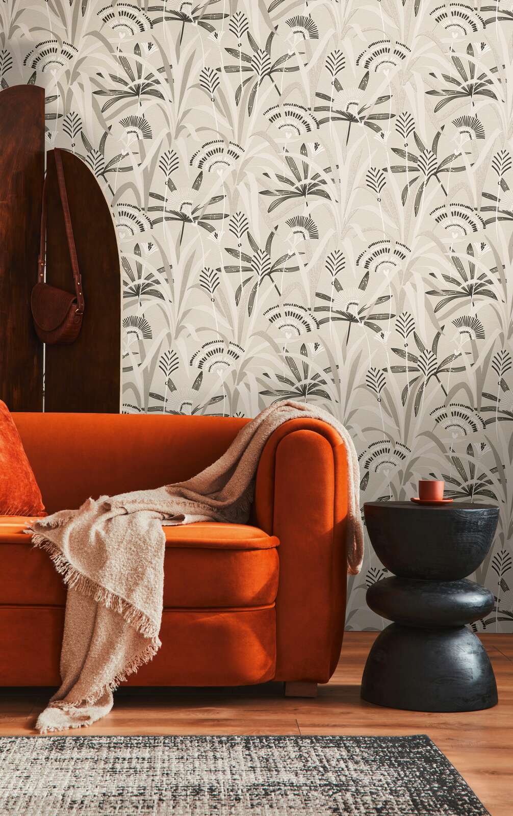 AS Creation French Affair 399361 living room with stylized botanical wallpaper behind a sofa and a side table.