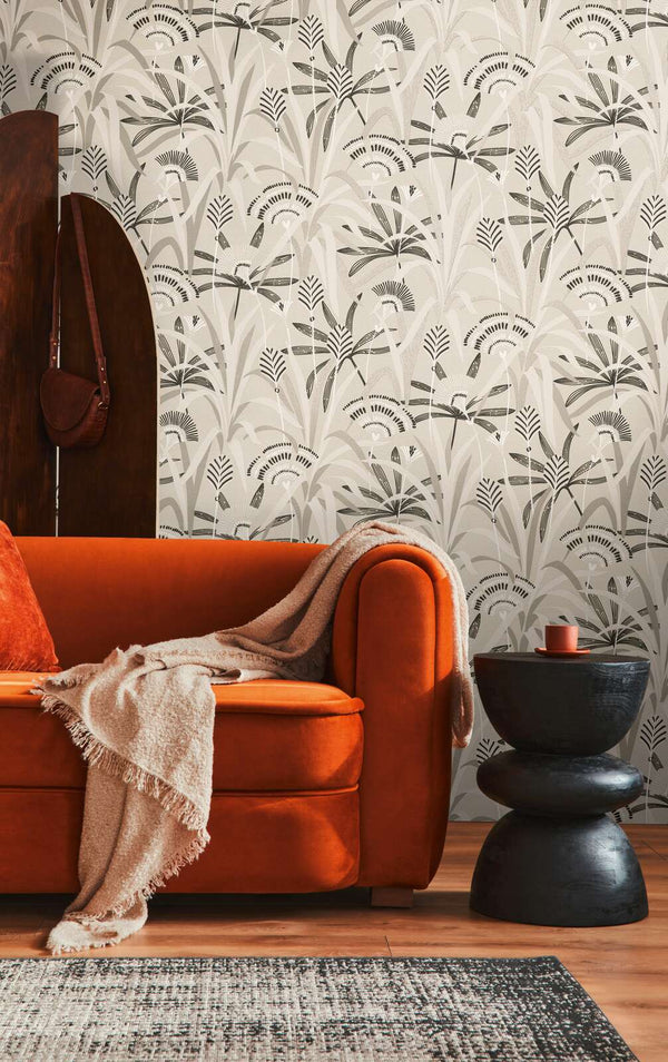 AS Creation French Affair 399361 living room with stylized botanical wallpaper behind a sofa and a side table.