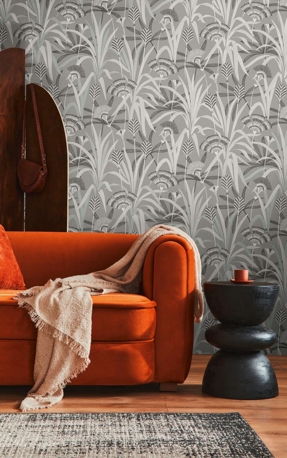AS Creation French Affair 399362 living room with botanical Black, Grey, Turquoise, White wallpaper behind a sofa and a side table.