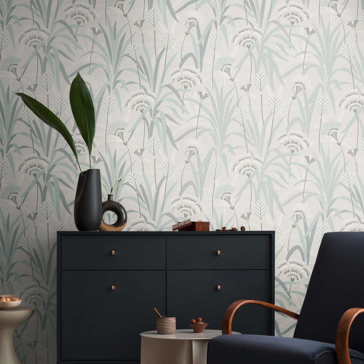 AS Creation French Affair 399363 stylized botanical pattern with long leaves and tufted flower heads in a repeating layout wallpaper on a living room feature wall.