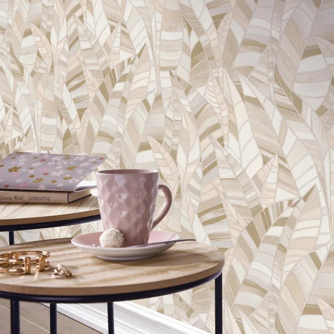 Erismann Elle Decoration 4 beige botanical wallpaper with layered leaf pattern and textured finish behind a minamalist side table