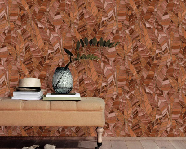 Erismann Elle Decoration 4 terracotta botanical wallpaper with layered leaf pattern and textured finish behind a leather cream bench
