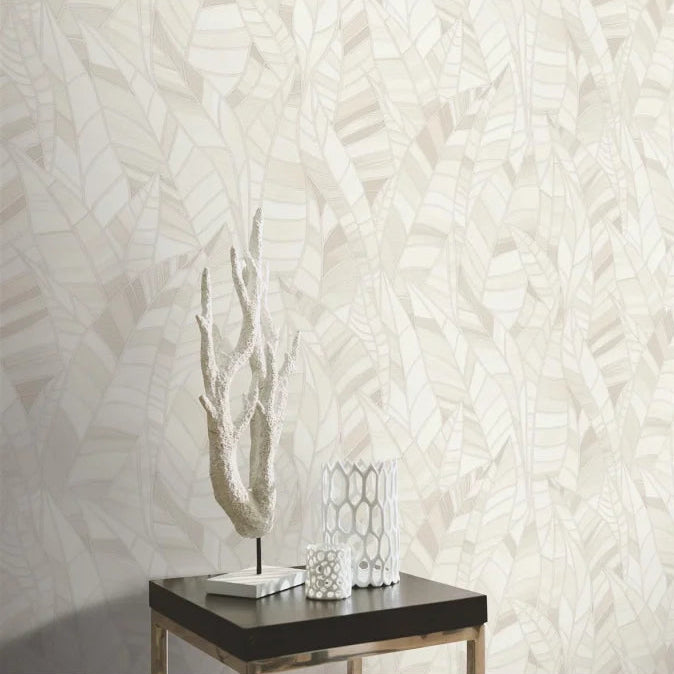 Erismann Elle Decoration 4 cream botanical wallpaper with subtle leaf pattern and textured finish behind a side table and statue