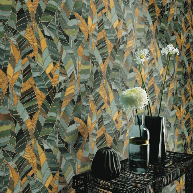 Erismann Elle Decoration 4 green botanical wallpaper with layered green and yellow leaf pattern and textured finish, in a room with vases and flowers on a table