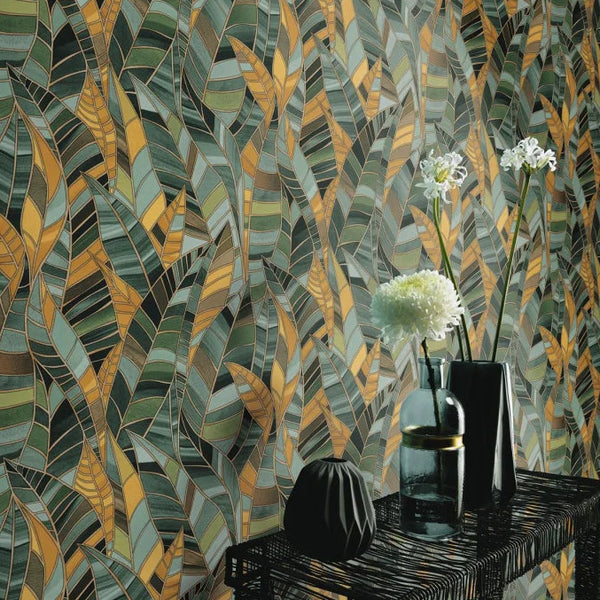 Erismann Elle Decoration 4 green botanical wallpaper with layered green and yellow leaf pattern and textured finish, in a room with vases and flowers on a table