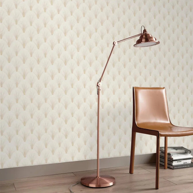 Erismann Elle Decoration Art Deco fan wallpaper in soft cream tones behind a minimal room with a leather chair and lamp
