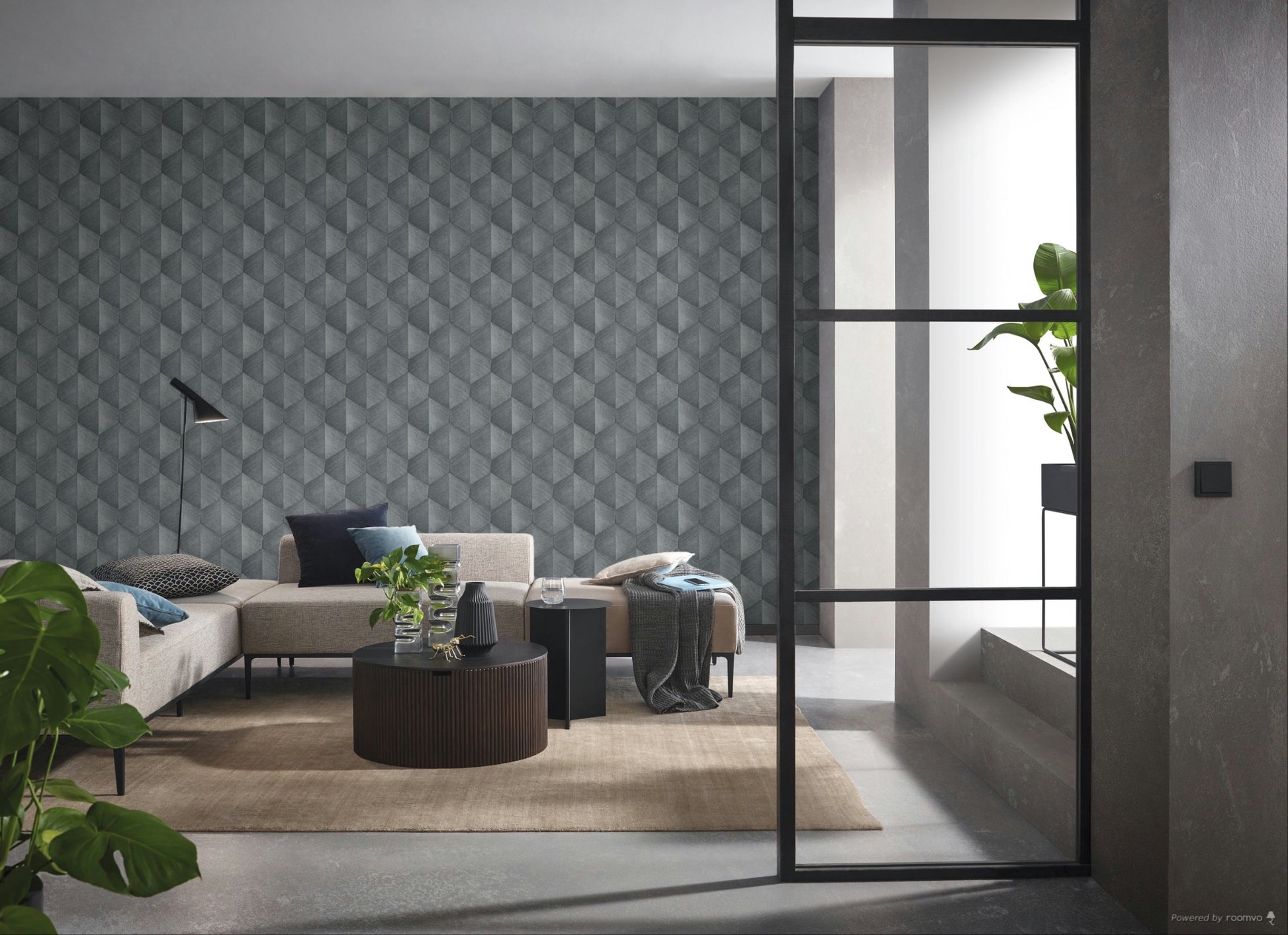 Erismann Fashion For Walls 4 10370-10 wallpaper modern lounge with geometric feature wall behind a neutral sectional, round coffee table, floor lamp, indoor plants and a large rug for a calm contemporary feel.